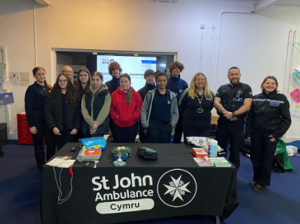 St John Ambulance Cymru and South Wales Police Cadets are working together to learn how to use an AED and perform CPR